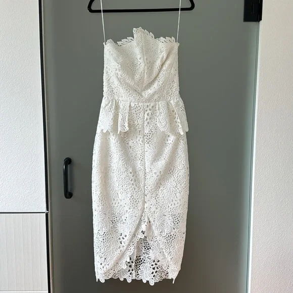 elliat white dress Elliatt Darcy Puff Shoulder Gown in while the asymmetrical skirt adds a dynamic Elliatt Yvette Ruffle Mini Dress